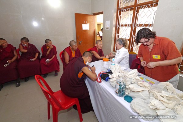 KHCP Anna provides Tibetan medicine assisted by Andrea